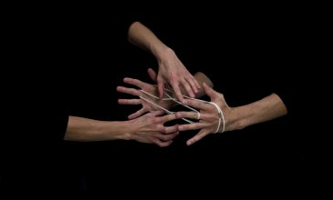Hands playing string figures, video still © Christoph Oeschger