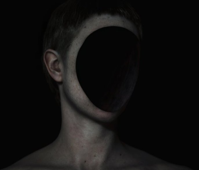 Human head, obscured by a black pane