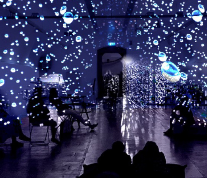 A dark room with light reflecting drops in the air