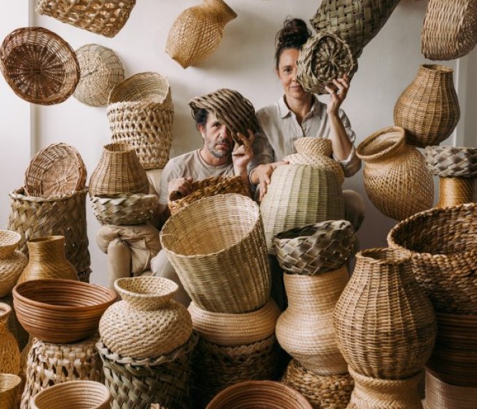 Two artists surrounded by baskets