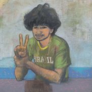Young man in green t-shirt shows peace sign with right hand