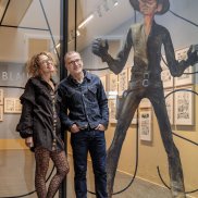 Anette Gehrig and Christophe Blain in front of the entrance to the exhibition