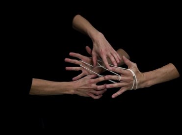 Hands playing string figures, video still © Christoph Oeschger