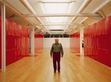 Künstler in einem großen raum umgeben von roten Wänden