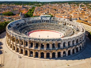 The aerial view of Arena of Nîmes, an old Roman city in the Occitanie region of southern France By Alexey Fedorenko