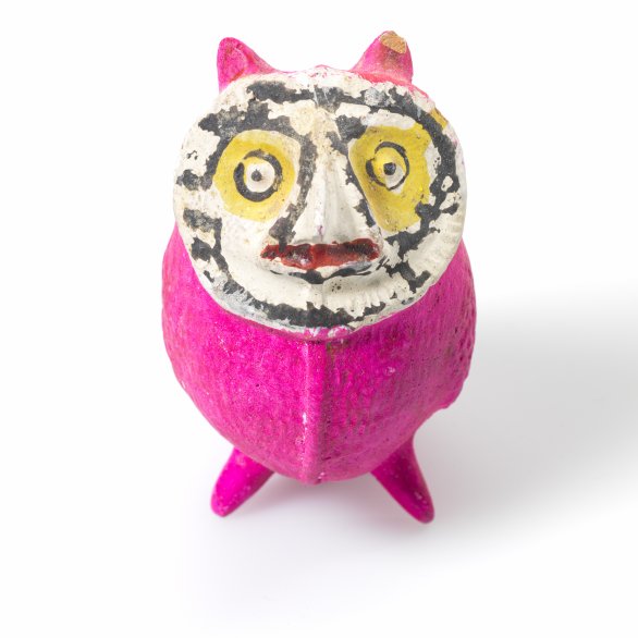 Figure of an owl with a pink belly, legs, and ears, and a large round face in black, white, and yellow.