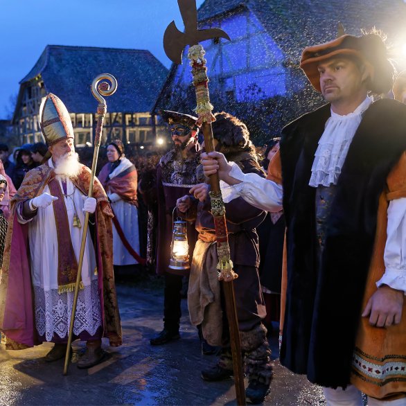 Saint Nicolas défile dans le musée, escorté par ses hallebardiers costumés.