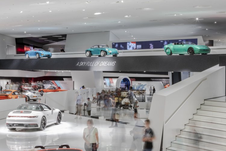 Section of the Porsche Museum exhibition, visitors marvel at the prologue. The words "A sky full of dreams" are emblazoned on the gallery.