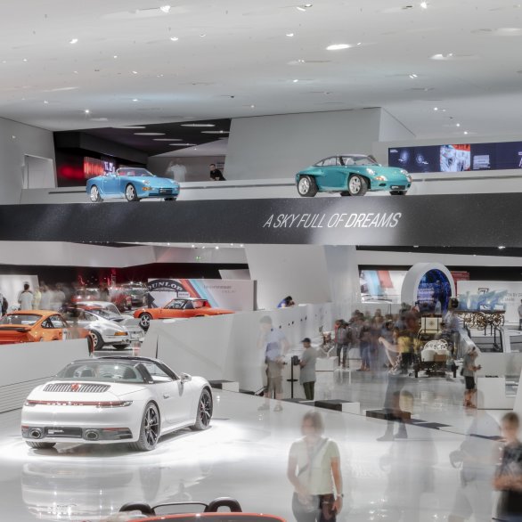Section of the Porsche Museum exhibition, visitors marvel at the prologue. The words "A sky full of dreams" are emblazoned on the gallery.